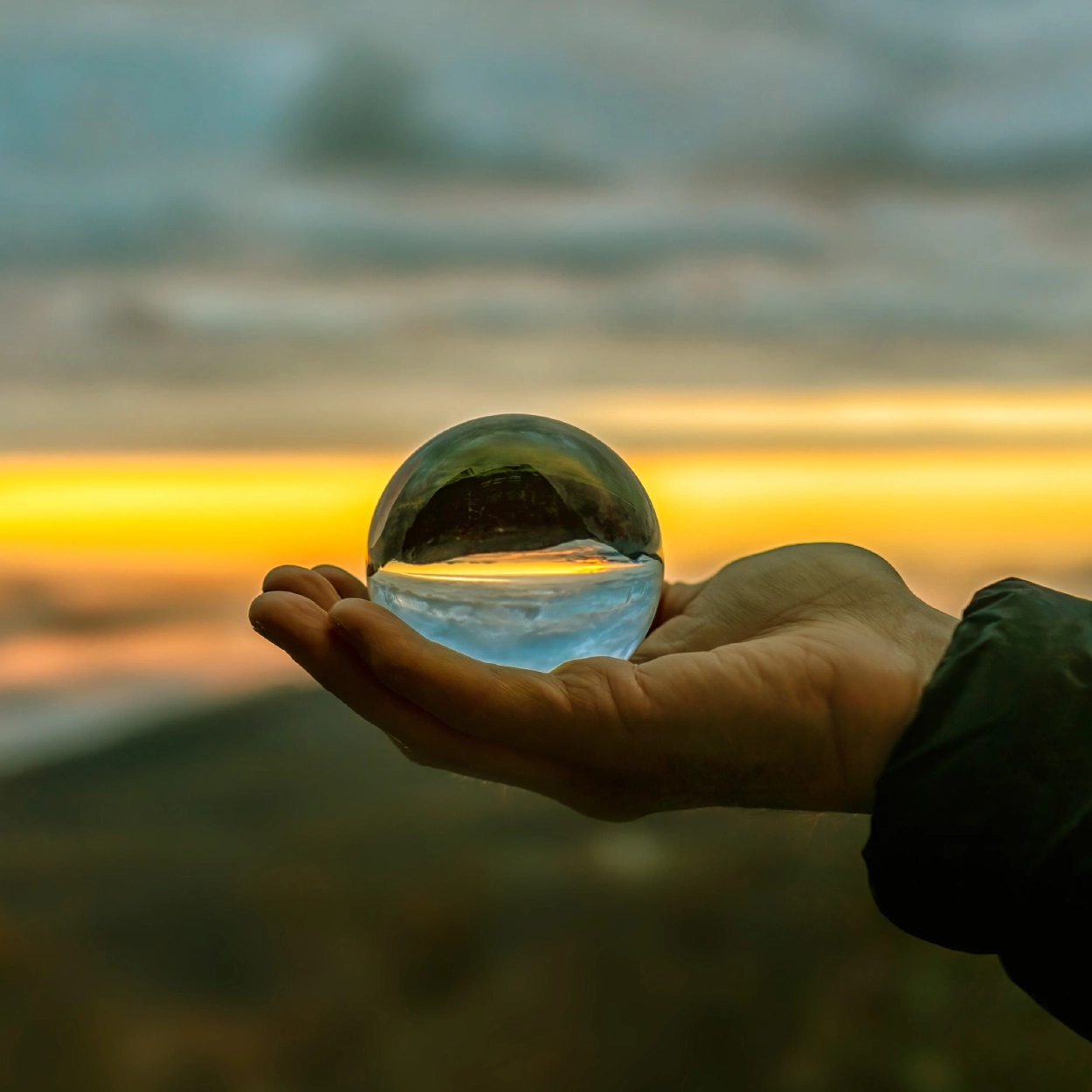 Close-up shot of a hand holding a crystal ball
