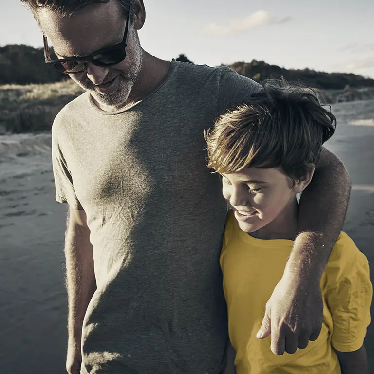 Father and son walking side by side, symbolizing the passage of wealth management to the next generations