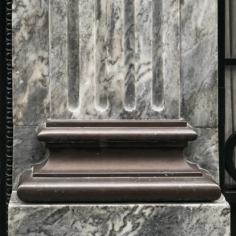 Detail of the bank's old logo carved in marble, symbolizing the legacy of Banco Carregosa